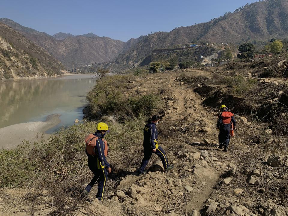 Rescuers arrive to search for bodies in the downstream of Alaknanda River in Rudraprayag, northern state of Uttarakhand, India, Monday, Feb.8, 2021. More than 2,000 members of the military, paramilitary groups and police have been taking part in search-and-rescue operations after part of a Himalayan glacier broke off Sunday and sent a wall of water and debris rushing down the mountain. (AP Photo/Rishabh R. Jain)