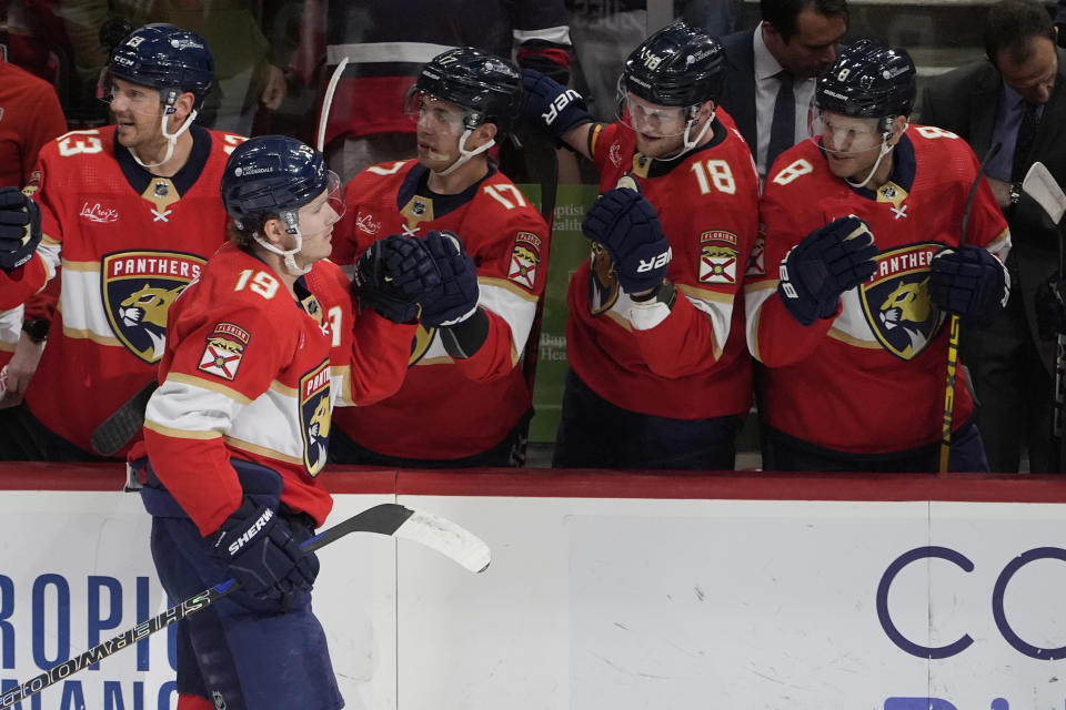 Florida Panthers left wing Matthew Tkachuk (19) is congratulated by his teammates after scoring a goal at the start of the first period of an NHL hockey game against the Columbus Blue Jackets, Thursday, April 11, 2024, in Sunrise, Fla. (AP Photo/Marta Lavandier)