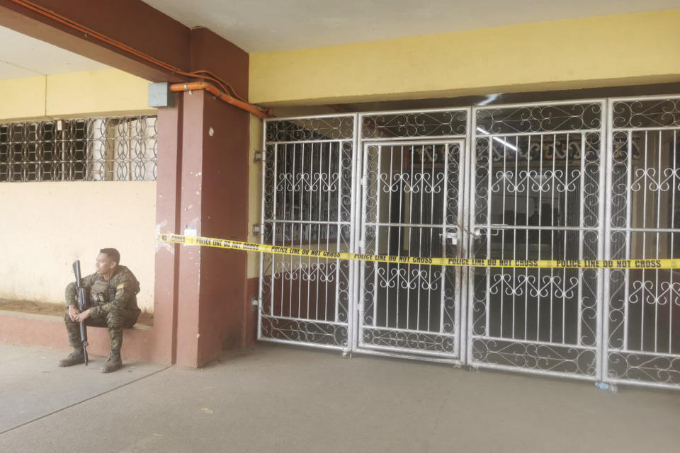 A Filipino trooper guards the entrance of the site where a bomb exploded in Marawi, southern Philippines on Sunday Dec. 3, 2023. A powerful explosion believed caused by a bomb ripped through a Catholic Mass and killed several people and wounded dozens of others Sunday in a predominantly Muslim city in the southern Philippines, officials said. (AP Photo/Froilan Gallardo)