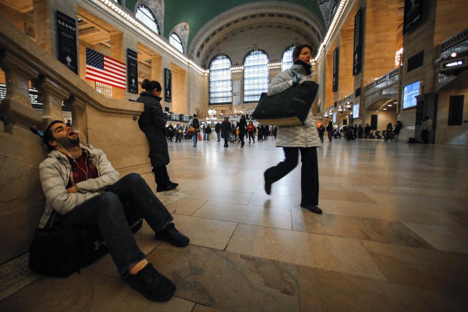 A commuter (L) takes a nap before his train departs from the Grand Central Station in New York, February 2, 2013. Grand Central Terminal, the doyenne of American train stations, is celebrating its 100th birthday. Opened on February 2, 1913, the iconic New York landmark with its Beaux-Arts facade is an architectural gem, and still one of America's greatest transportation hubs. (REUTERS/Eduardo Munoz)