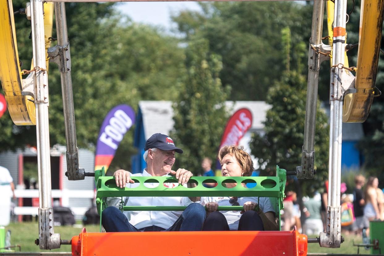 GOP presidential candidate Asa Hutchinson and his wife Susan ride the double Ferris wheel during day 9 of the Iowa State Fair on Friday, August 18, 2023 in Des Moines.