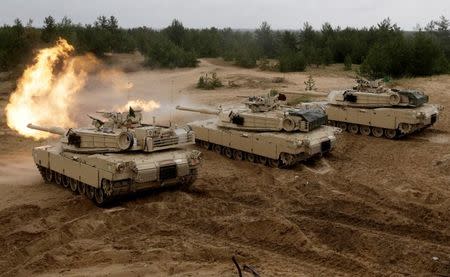 FILE PHOTO: U.S. M1 Abrams tanks fire during the "Saber Strike" NATO military exercise in Adazi, Latvia, June 11, 2016. REUTERS/Ints Kalnins/File Photo