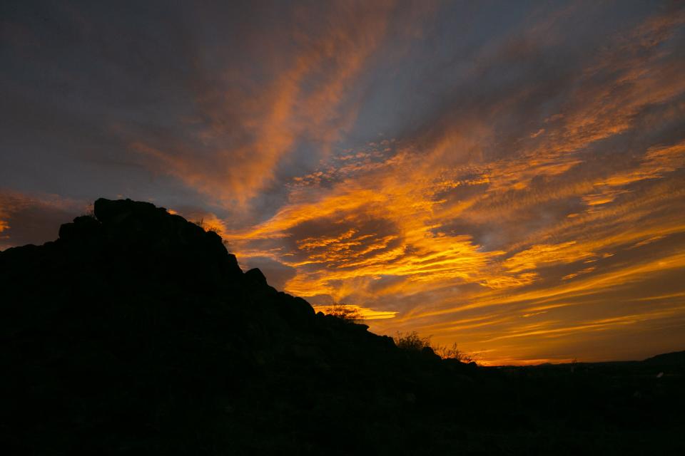 The sun sets at the Painted Rock Petroglyph Site, managed by the Bureau of Land Management, outside of Gila Bend on Feb. 3, 2021.