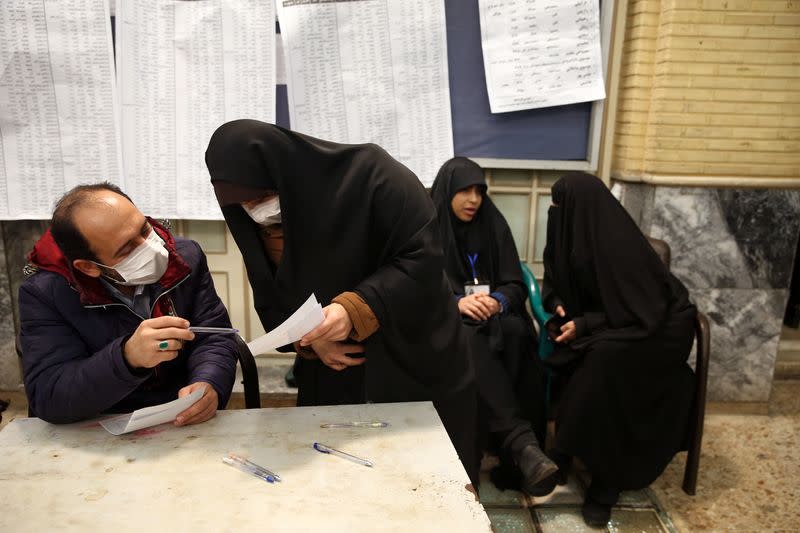 Iranian man casts his vote during parliamentary elections at a polling station in Tehran