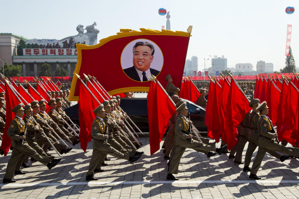 North Korean soldiers march with a float showing late North Korean leader Kim Il Sung during a parade for the 70th anniversary of North Korea's founding day in Pyongyang, North Korea, Sunday, Sept. 9, 2018. North Korea staged a major military parade, huge rallies and will revive its iconic mass games on Sunday to mark its 70th anniversary as a nation. (AP Photo/Ng Han Guan)