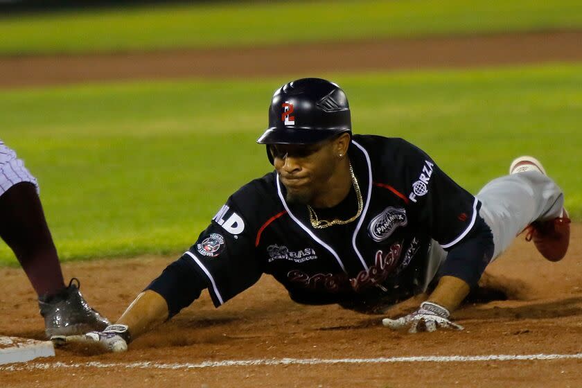 Johnny Davis, of Tecolotes, slides toward a base during a game against Algodoneros Union Laguna