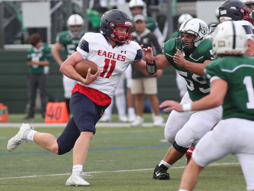 Eastchester quarterback Aidan Schultz (11) looks for some running room in the Brewster defense during football action at Brewster High School Sept. 30, 2023. Eastchester won the game 21-0. 
