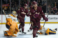 Arizona Coyotes center Jack McBain (22) celebrates after scoring a goal on Nashville Predators goaltender Juuse Saros (74) during the first period of an NHL hockey game Thursday, March 28, 2024, in Tempe, Ariz. (AP Photo/Rick Scuteri)