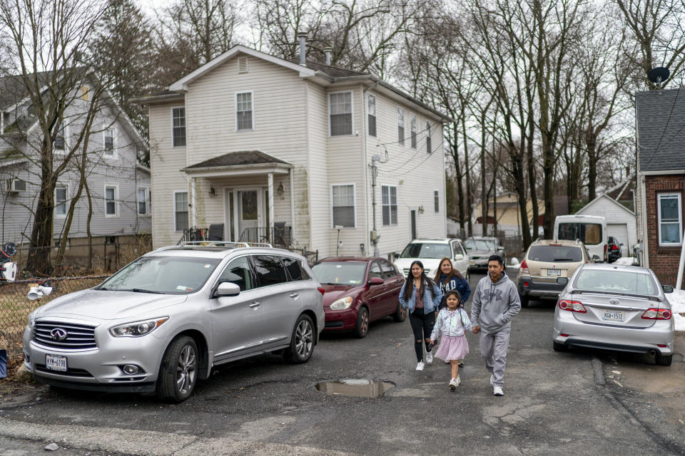 Ecuadorian migrant Klever Ortega, right, leaves home for a shopping trip with members of his family, Saturday, March. 3, 2023, in Spring Valley, N.Y. Ecuador — long known for remarkably low rates of crime, despite sitting in South America's cocaine heartland — has been struggling economically, fighting higher violence and losing its people in record numbers. Like Ortega, many are headed to the U.S. (AP Photo/Eduardo Munoz Alvarez)