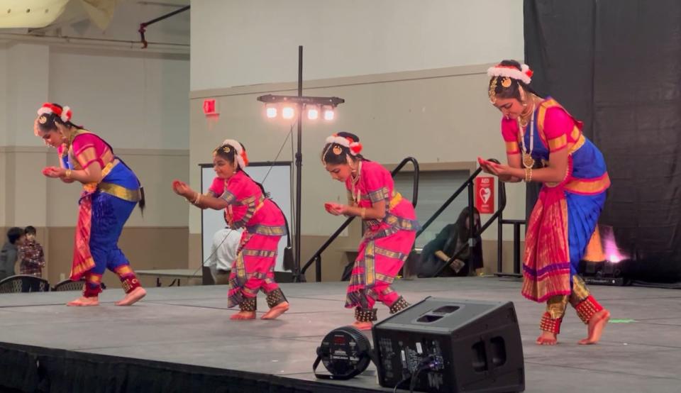 Children performing a traditional Tamil dance on the main stage of the event.