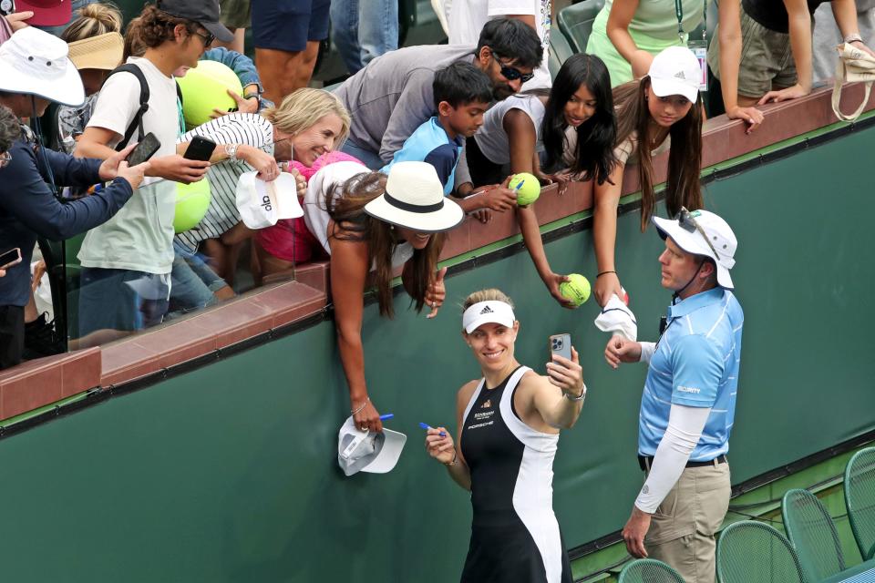 Angelique Kerber takes a selfie with fans after defeating Veronika Kudermetova 6-4, 7-5 in their third-round match at the BNP Paribas Open in Indian Wells, Calif., on Sunday, March 10, 2024.