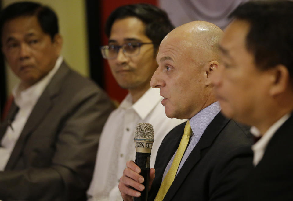 Australian Federal Police acting senior liason officer Graeme Marshall, second from right, answers questions from reporters during a press conference in Manila, Philippines on Thursday July 25, 2019. Philippine authorities announced on Thursday the capture of The European Union Agency for Law Enforcement Cooperation or EUROPOL's most wanted criminal for the production and distribution of child sexual exploitation materials on the dark-web in central Philippines. Nelson Siacor Torayno, 32, was arrested on April 12, 2019 in Cebu City where thousands of images, videos depicting children being sexually abused by an adult were found in his possession. In 2018 Queensland Police Service monitored an online surveillance that pieced together information on the location of Torayno which was likely in the Philippines and referred the case to the National Bureau of Investigation and the Philippine National Police. (AP Photo/Aaron Favila)