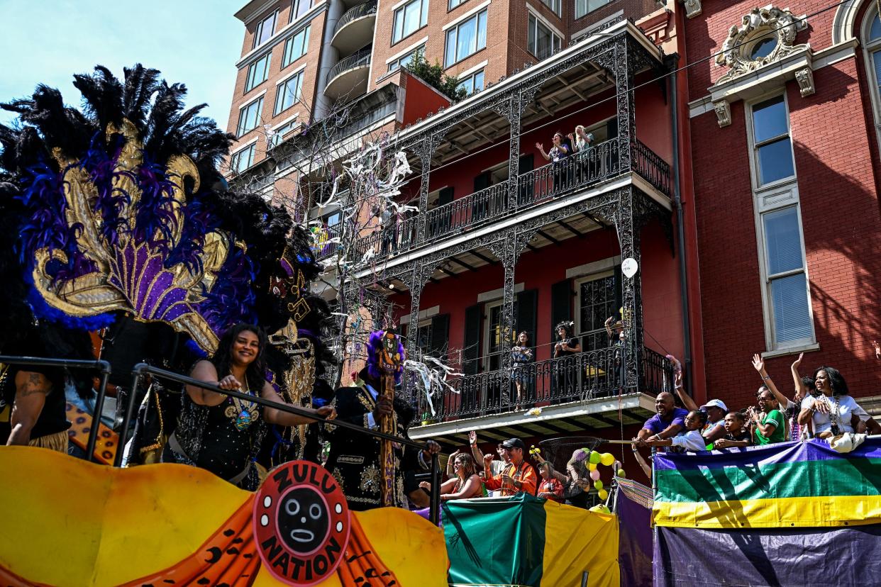 Revellers catch beads from a float in the 2023 Zulu Social Aid and Pleasure Club parade during a Mardi Gras celebration in New Orleans, Louisiana, February 21, 2023.