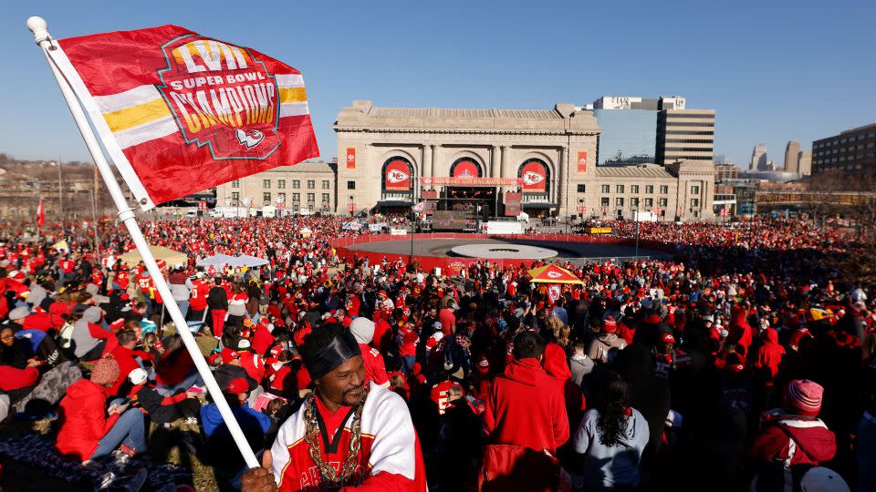 Kevin Moore of Kansas City waves a flag in front of Union Station before the Kansas City Chiefs Super Bowl LVIII victory parade on Wednesday in Kansas City. - David Eulitt/Getty Images