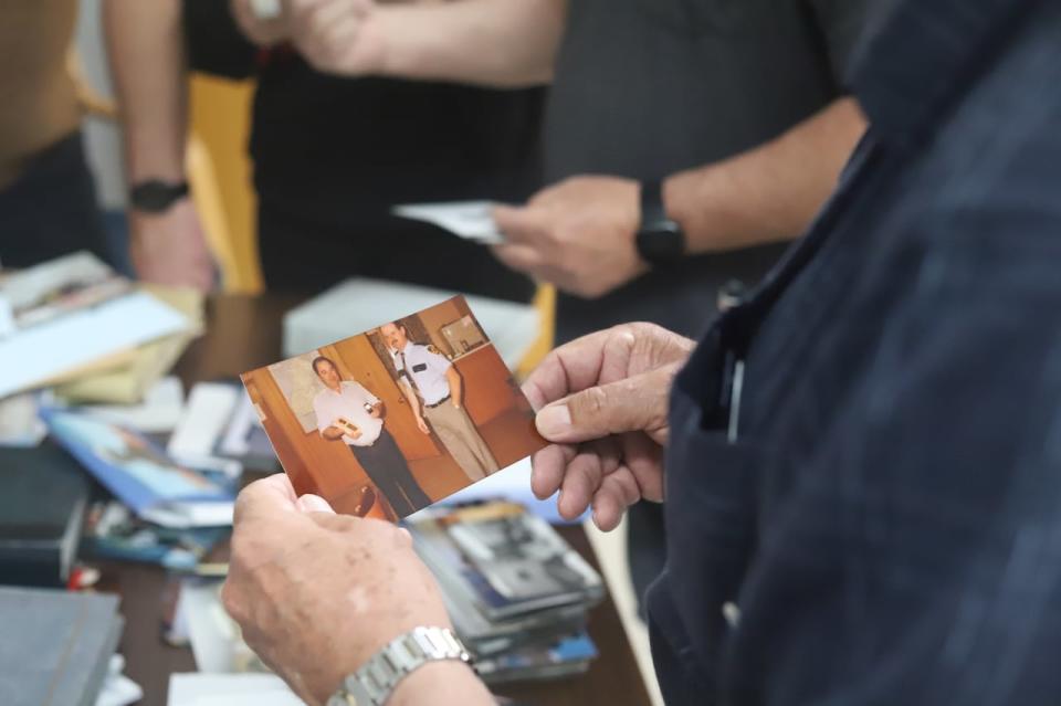 Wyman Harris holds a photo of himself receiving an award of recognition when he was with the O'Leary Fire Department.