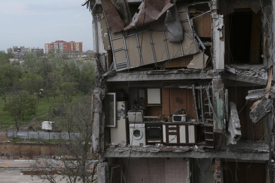 A part of an apartment is seen at the side of damaged during a heavy fighting buildings in Mariupol, in territory under the government of the Donetsk People's Republic, eastern Ukraine, Thursday, May 13, 2022. (AP Photo)