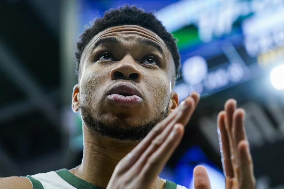 Milwaukee Bucks' Giannis Antetokounmpo pauses before an NBA basketball game against the Toronto Raptors Saturday, Jan. 15, 2022, in Milwaukee. (AP Photo/Morry Gash)