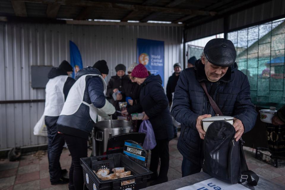 A local man packs a hot meal received from volunteers of 