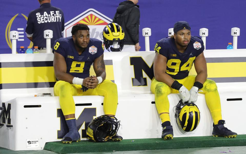 Michigan Wolverines linebacker Derrick Moore (8) and Michigan Wolverines defensive lineman Kris Jenkins (94)  the bench after 51-45 loss to the TCU Horned Frogs in the Fiesta Bowl Saturday, December 31, 2022.