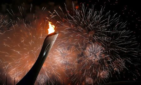 Fireworks explode after the Olympic Cauldron is been lit during the opening ceremony of the 2014 Sochi Winter Olympics, February 7, 2014. REUTERS/Shamil Zhumatov