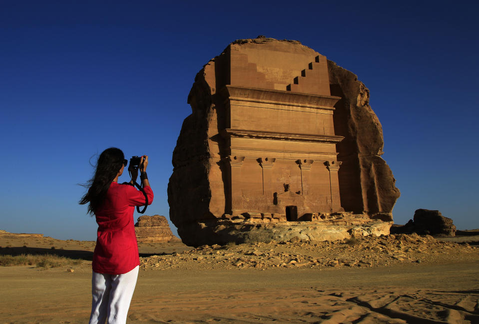 FILE -In this photograph made on Thursday, May 10, 2012, a foreign tourist visits the Abu Lawha, the largest Nabataean tomb at the desert archaeological site of Madain Saleh, in Al Ula city, 1043 km (648 miles) northwest of the capital Riyadh, Saudi Arabia. The CEO overseeing Saudi Arabia’s royal commission for its historic al-Ula site has been arrested on corruption and money-laundering charges over some $55 million in contracts. (AP Photo/Hassan Ammar, File)