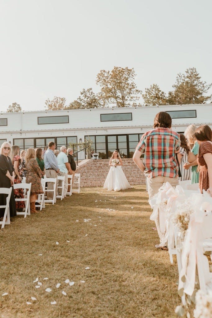 Lexi and Brady Butler on their wedding day at Lilly Creek Farm in Belden, Mississippi on September 30, 2023. Sandra Lynn Henson, 57, pleaded guilty on Wednesday, to crashing the couple's wedding reception and stealing from at least one guest - a crime court records show the woman is no stranger to.