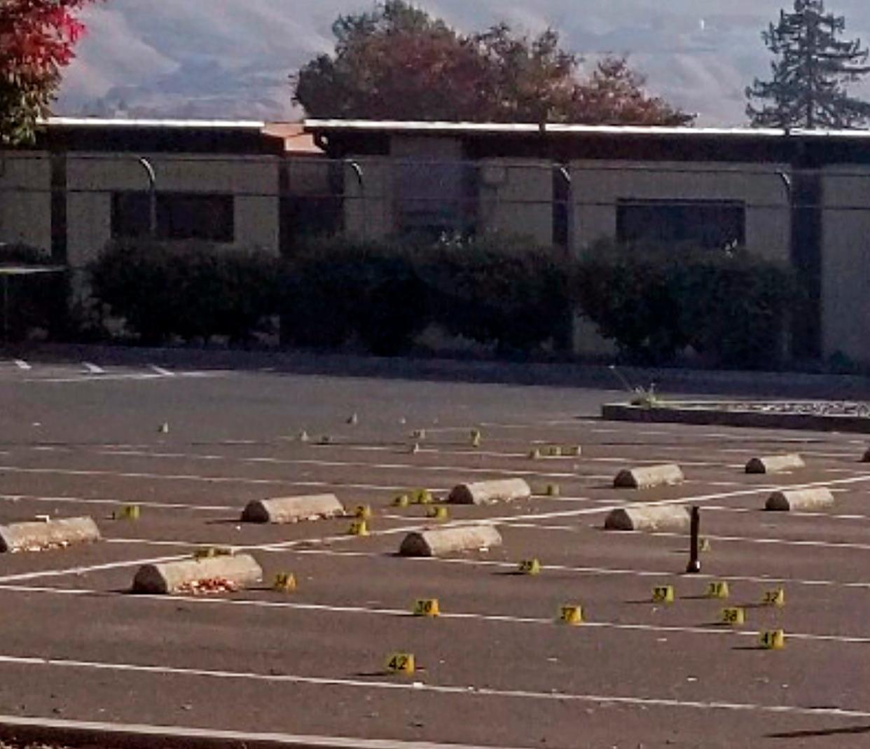 Crime scene evidence markers dot the parking lot of the Searles Elementary School in Union City, Calif.