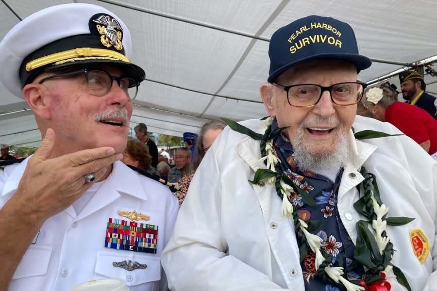 FILE – Ira Schab, right, who survived the attack on Pearl Harbor as a sailor on the USS Dobbin, talks with reporters while sitting next to his son, retired Navy Cmdr. Karl Schab, on Dec. 7, 2022, in Pearl Harbor, Hawaii. Eighty-two years later, Schab plans to return to Pearl Harbor on the anniversary of the attack to remember the more than 2,300 servicemen killed. He’s expected to be one of just six survivors at the ceremony commemorating the event that propelled the United States into World War II. (AP Photo/Audrey McAvoy, File)