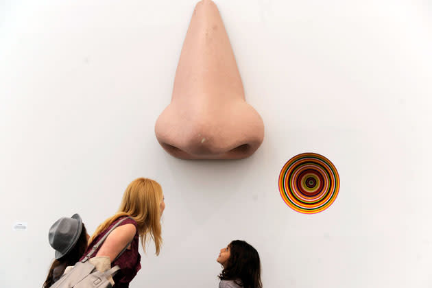 Visitors look over the sculpture "Vortex Eau De Parfum" by Jim Lampie at the Frieze Art Fair in New York, May 5, 2012. REUTERS/Keith Bedford