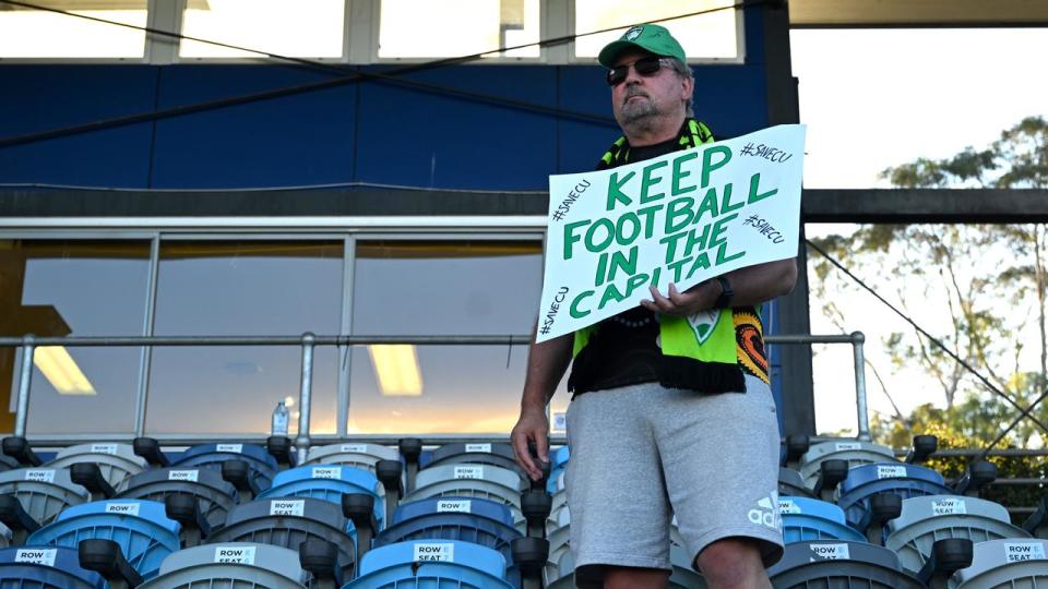 A Canberra United fan with a sign.