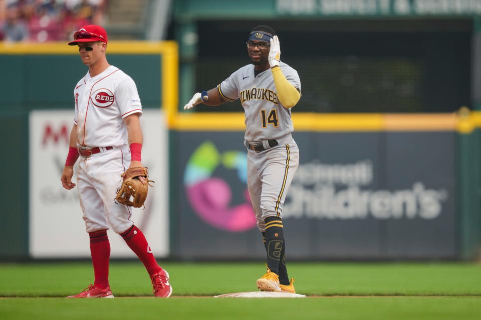 Brewers third baseman Andruw Monasterio gestures toward the dugout after hitting a a go-ahead RBI single during the eighth inning against the Reds on July 16.