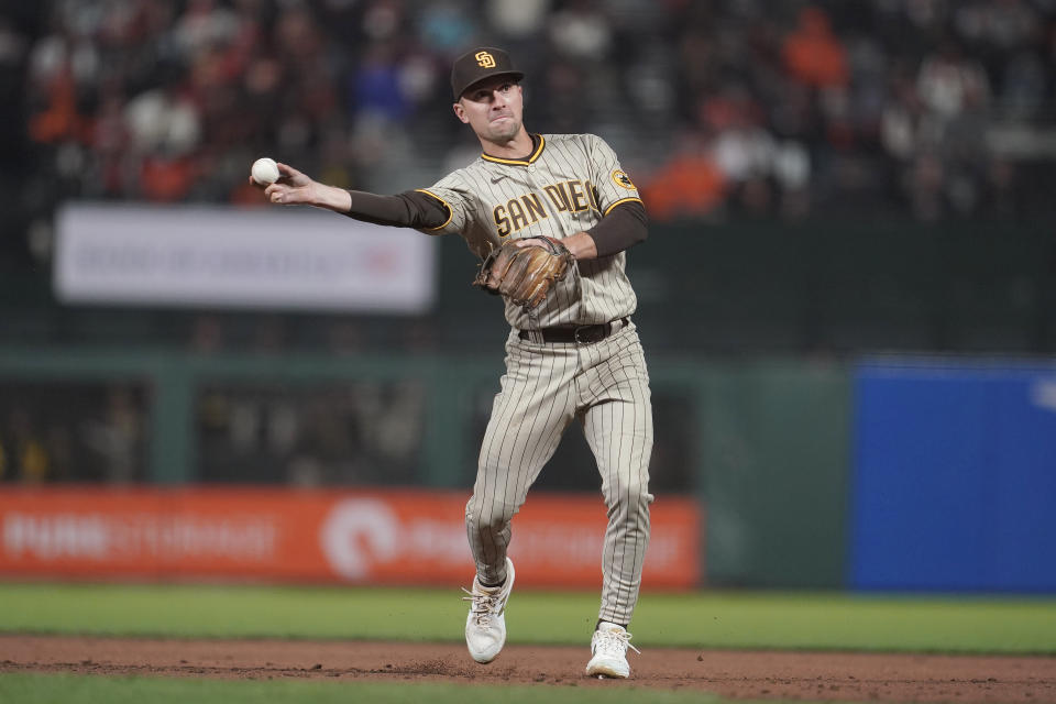 San Diego Padres second baseman Adam Frazier throws out San Francisco Giants' Brandon Belt at first base during the third inning of a baseball game in San Francisco, Wednesday, Sept. 15, 2021. (AP Photo/Jeff Chiu)
