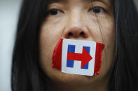 <p>A former Bernie Sanders delegate wears a Hillary Clinton presidential campaign sticker over her mouth as she protests during the third session at the Democratic National Convention in Philadelphia, Pa., July 27, 2016. (Photo: Carlos Barria/Reuters)</p>