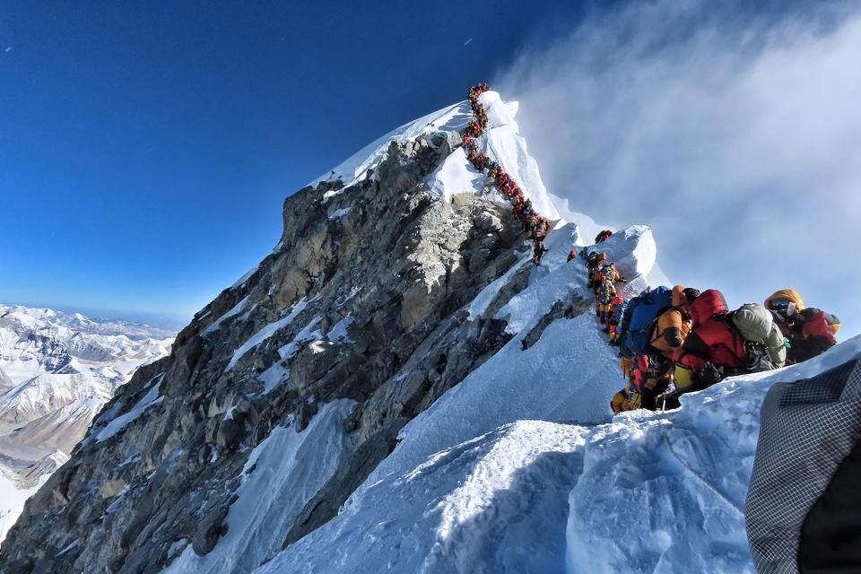 This handout photo taken on May 22, 2019 and released by climber Nirmal Purja's Project Possible expedition shows heavy traffic of mountain climbers lining up to stand at the summit of Mount Everest.