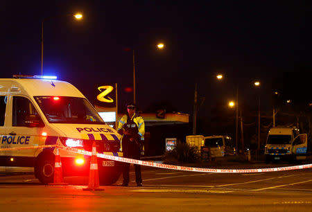 An armed police officer stands guard in a perimeter outside Linwood mosque after Friday's gunmen attacks, in Christchurch, New Zealand March 16, 2019. REUTERS/Edgar Su