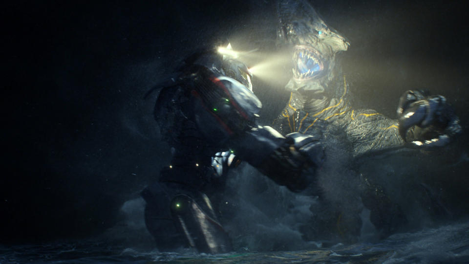 This film publicity image released by Warner Bros. Pictures shows the Gipsy Danger robot battling the Knifehead monster in a scene from "Pacific Rim." "Pacific Rim" fulfills a very basic boyhood fantasy: big ol' robots and giant monsters slugging it out. The concept to Guillermo del Toro's "Godzilla"-sized film is about as simple as it gets, but actually constructing such mammoth creations is a far more arduous undertaking. (AP Photo/Warner Bros. Pictures)