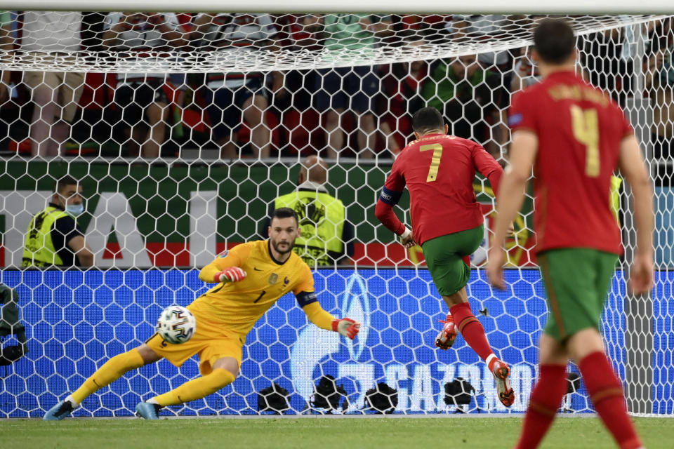 Portugal's Cristiano Ronaldo scores the opening goal from the penalty spot during the Euro 2020 soccer championship group F match between Portugal and France at the Puskas Arena in Budapest, Wednesday, June 23, 2021. (Franck Fife, Pool photo via AP)