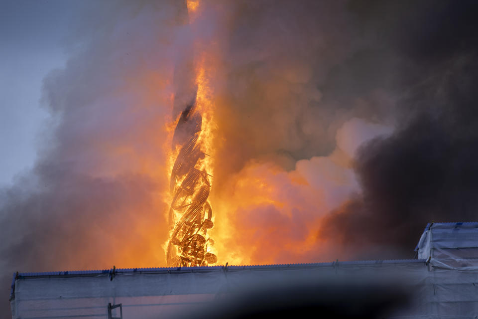 Fire and smoke rise out of the Old Stock Exchange, Boersen, in Copenhagen, Denmark, Tuesday, April 16, 2024. One of Copenhagen’s oldest buildings is on fire and its iconic spire has collapsed. The copper roof of the 17th-century Old Stock Exchange, or Boersen, that was once Denmark’s financial center, was engulfed in flames Tuesday. (Ida Marie Odgaard/Ritzau Scanpix via AP)