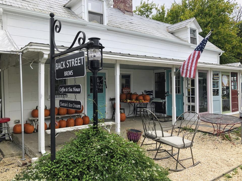 If you're looking for common ground in America these days, think coffee grounds. In Lovettsville, Va., a politically polarized town, where Republicans, Democrats and the non-aligned converge at Back Street Brews, seen on Oct. 12, 2021. At the café, civility is served with the cappuccino and people are just neighbors. Almost a year after the Jan. 6 Capitol insurrection, it's clear that there is a warring America – loud, coarse, power hungry — and a quieter one of neighbors, social ties and face-to-face community. (AP Photo/Cal Woodward)