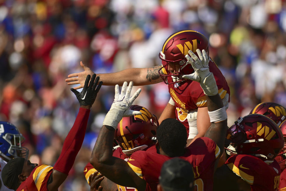 Washington Commanders place kicker Austin Seibert, top, celebrates with teammate after kicking the game-winning field goal against the New York Giants during the second half of an NFL football game in Landover, Md., Sunday, Sept. 15, 2024. (AP Photo/Steve Ruark)