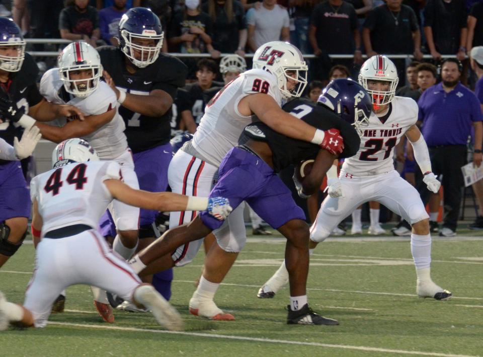 Lake Travis lineman Griffen Willis, wrapping up San Marcos running back Jaidyn Brown last season, has signed to play college football at Navy.