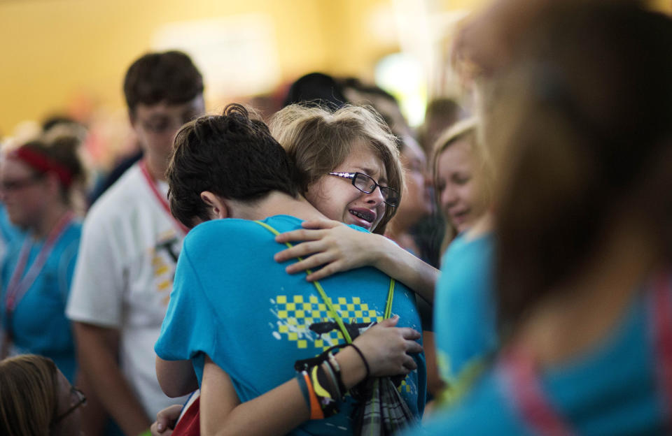 <p>Kristin Moorehead, 13, of Tampa, Fla., right, says goodbye to A.J. Dorough, 13, of Covington, Ga., as they leave to go home from Camp Twitch and Shout, a camp for children with Tourette’s Syndrome in Winder, Ga., July 18, 2014. (AP Photo/David Goldman) </p>