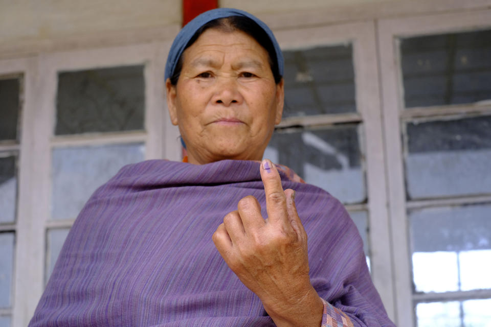 An elderly Angami Naga woman displays the indelible ink mark on her finger after casting her vote in Chedema village, in the northeastern Indian state of Nagaland, Friday, April 19, 2024. (AP Photo/Yirmiyan Arthur)