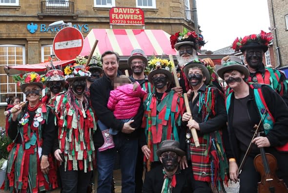 David Cameron poses with blacked-up Morris dancers at festival