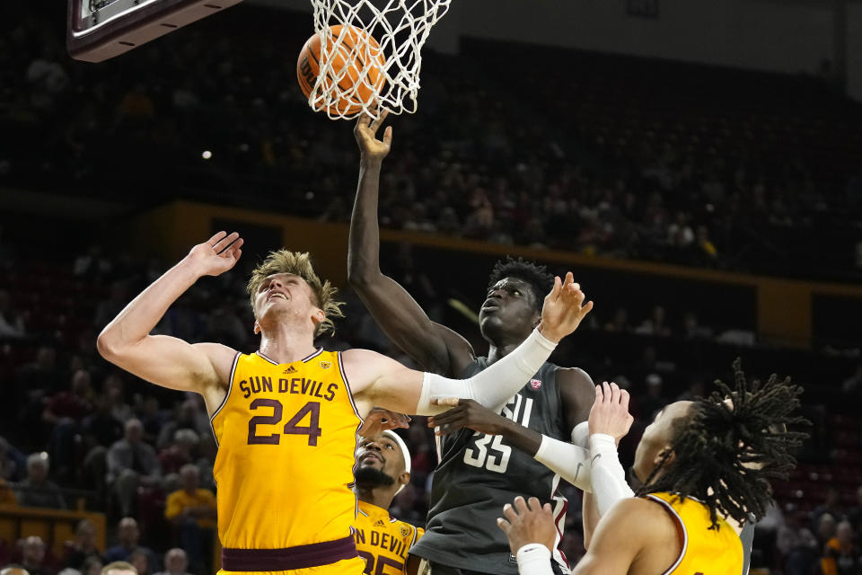 Washington State forward Mouhamed Gueye (35) grabs a rebound over Arizona State forward Duke Brennan (24) as Arizona State guard Frankie Collins, right, watches during the first half of an NCAA college basketball game in Tempe, Ariz., Thursday, Jan. 5, 2023. (AP Photo/Ross D. Franklin)