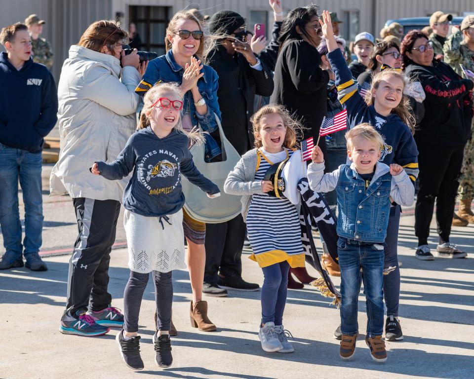 Lindy Wood (with sunglasses) waits for her husband to come home on the USS The Sullivans along with her excited children, Sally Caroline, 10, Paisley, 8, Piper, 6, and Calvin, 4. The ship arrived to Naval Station Mayport the day before Thanksgiving.