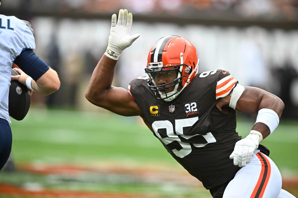 Cleveland Browns defensive end Myles Garrett (95) pressures Tennessee Titans quarterback Ryan Tannehill, left, during the first half Sunday in Cleveland.