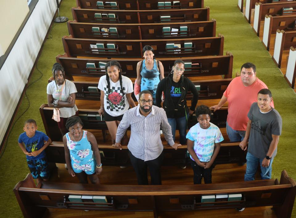 Pastor Darrell Cook, center, is joined inside Wayne Park Church by young people who have newly-registered for the NAACP in Erie on July 5, 2023. Cook is launching a peace plan with other pastors to address youth violence and other concerns.