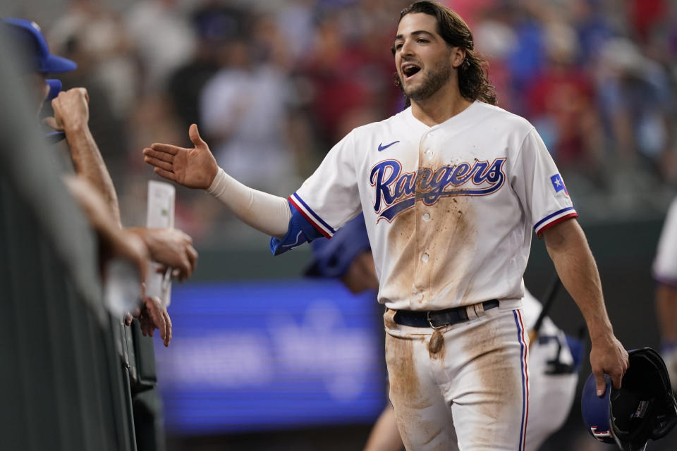 Texas Rangers Josh Smith is congratulated after running out an inside-the-park home run during the sixth inning of a baseball game against the Oakland Athletics in Arlington, Texas, Monday, July 11, 2022. Rangers' Leody Taveras also scored on the play. (AP Photo/LM Otero)