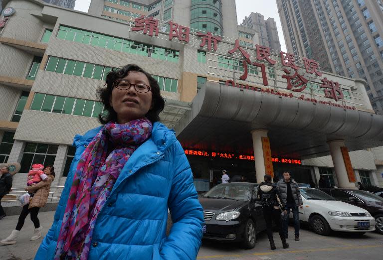 Doctor Lan Yuefeng, a former hospital ultrasound chief standing outside the Mianyang People's Hospital where she used to work in Mianyang, Sichuan Province February 23, 2014